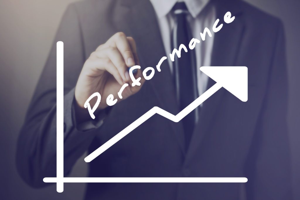 Businessman writing increasing positive Performance chart upward - indicates better performance measure such as company sales employee management income etc.